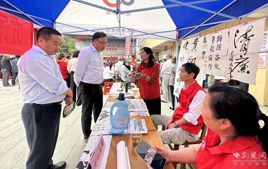 “文化惠民”攤位上，志愿者展示書法作品_副本.jpg
